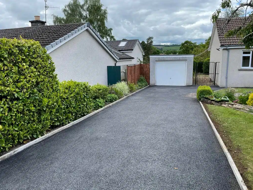 Fresh tarmac driveway with brick kerbing