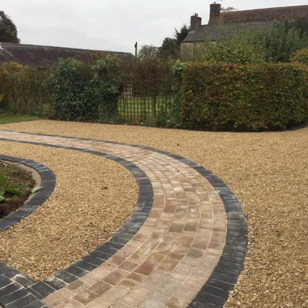 Landscaped driveway with curved paving feature